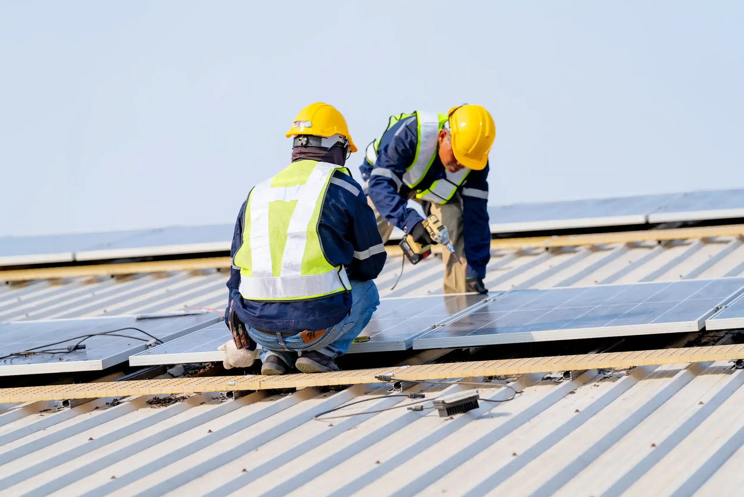 Solar installation technicians working on residential rooftop panels in Rockhampton.