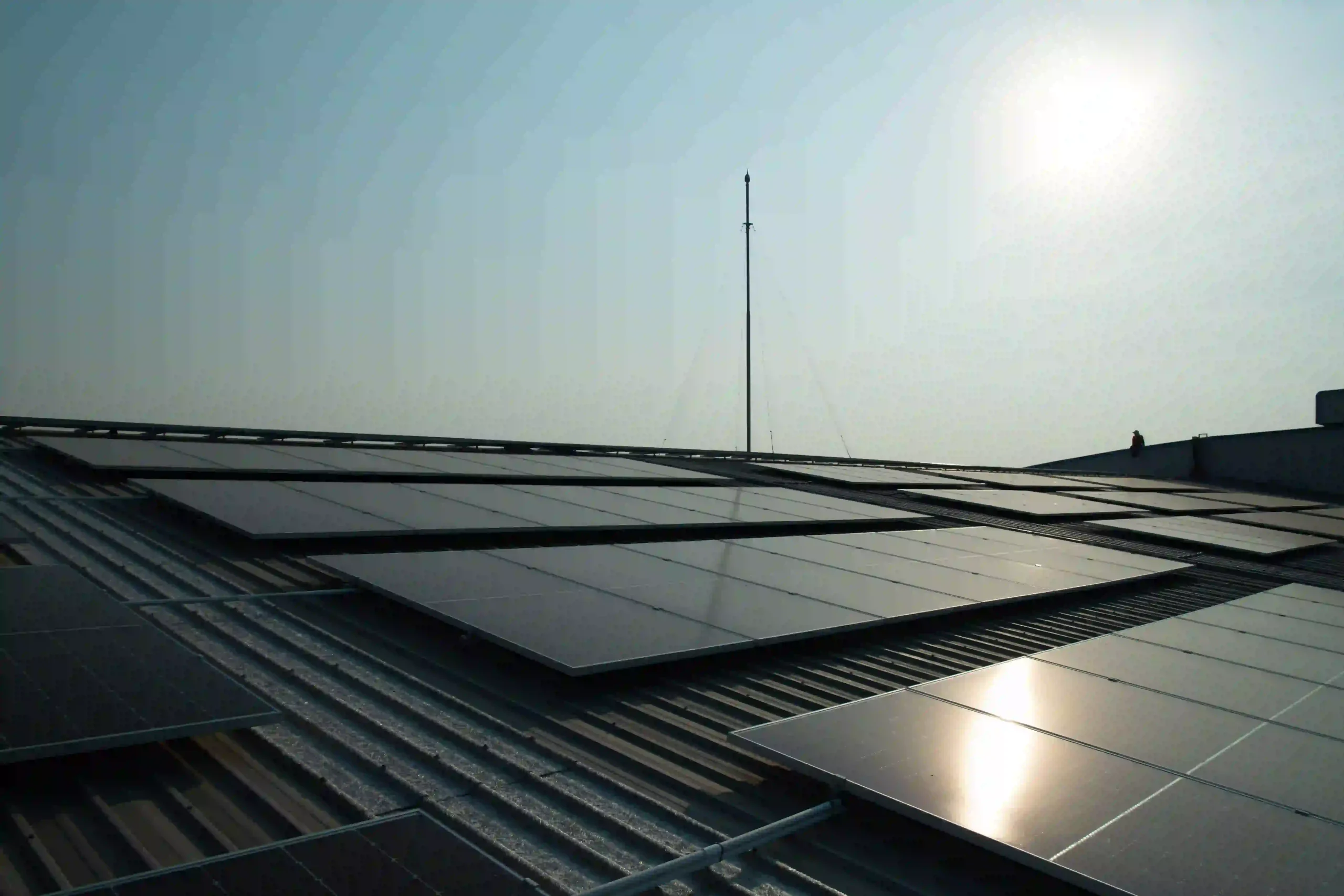 Rooftop solar panels in Rockhampton reflecting daylight during installation.