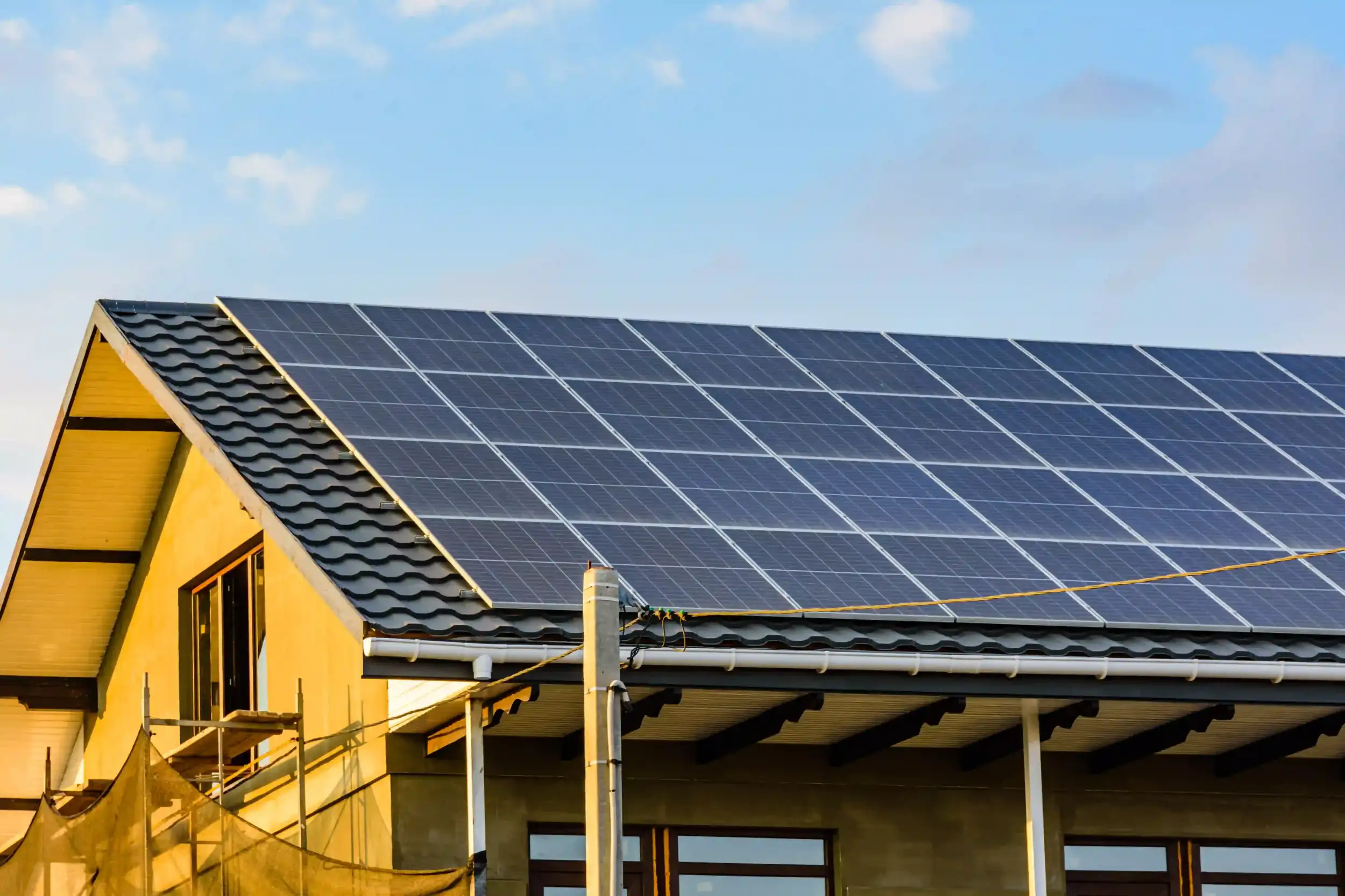 A home rooftop covered with modern solar panels installed under clear skies, representing professional Solar Services in Berserker.